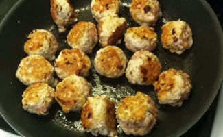Meatballs cooking in frying pan