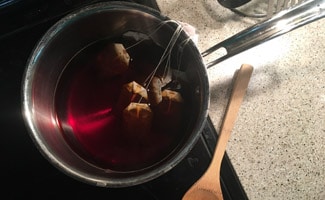 Tea bags in pot on stove