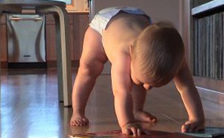 Baby crawling with books