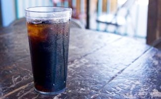 Cola with Ice on Table