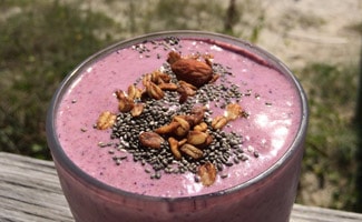 Glas of smoothie at the beach
