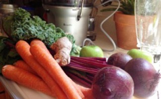 Juicer on the counter with veggies